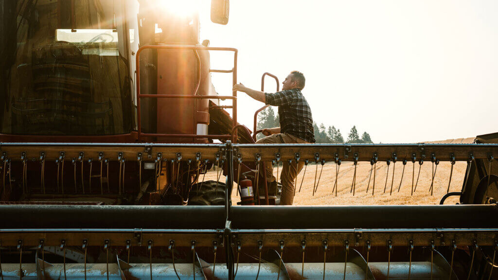 Farmer harvesting after following his commercial loan pre application checklist