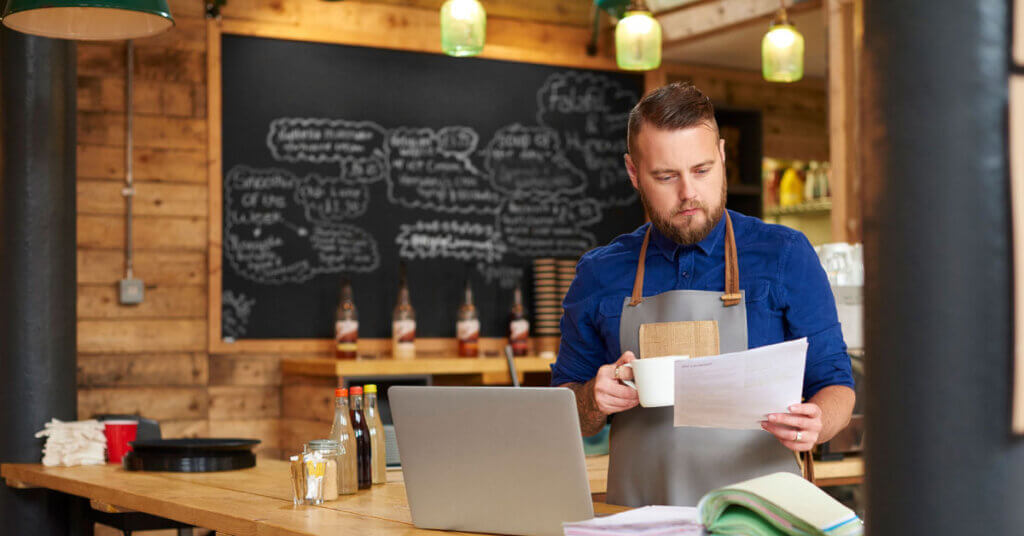 small business coffee shop owner doing business in his shop