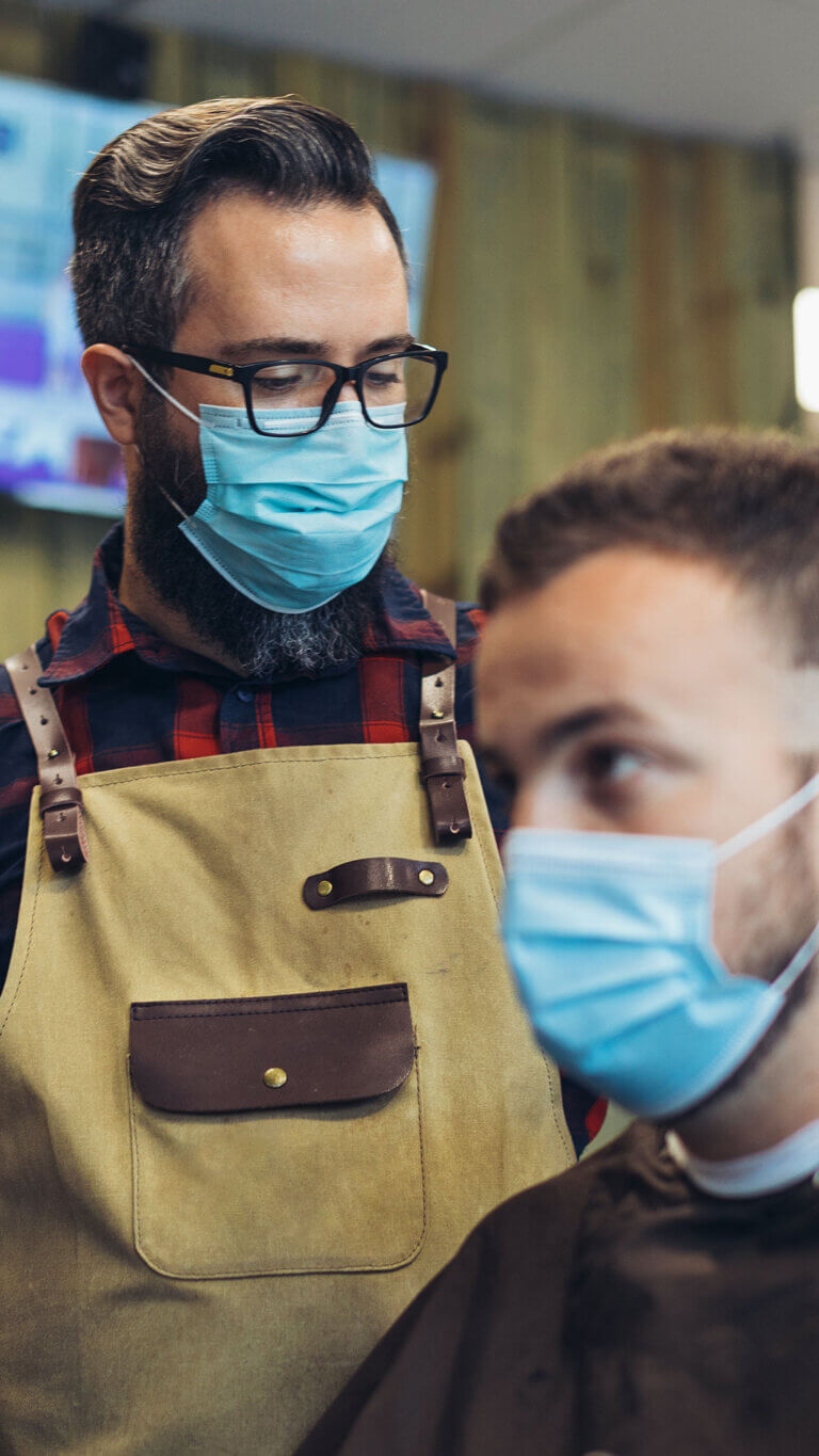 young man at a barbershop opened with sba 7a loans