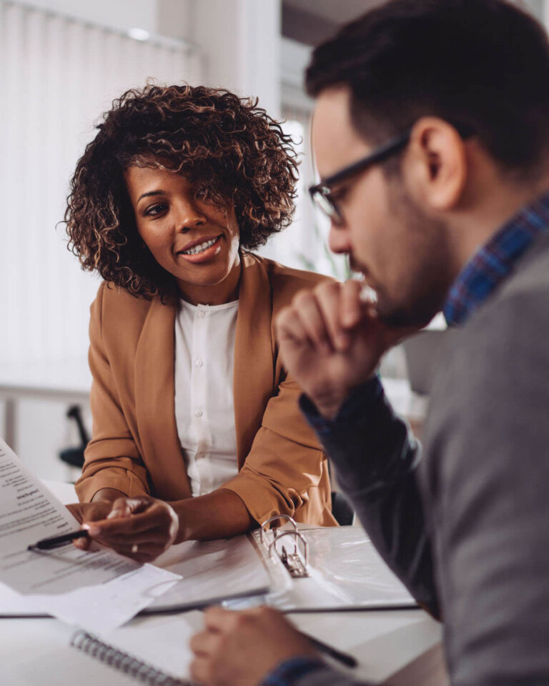 Female loan expert discussing business loan details with a male client