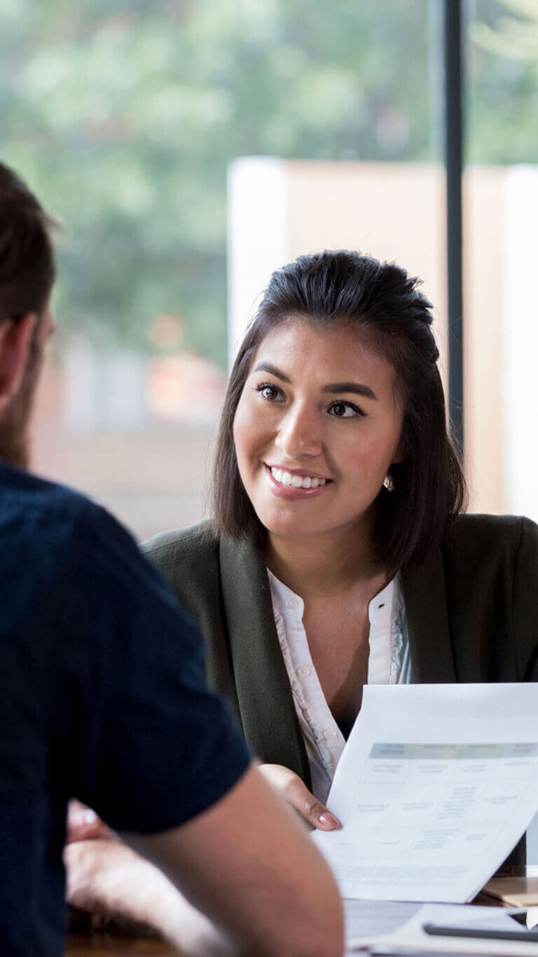 Commercial loan specialist discussing loan terms with her small business client.