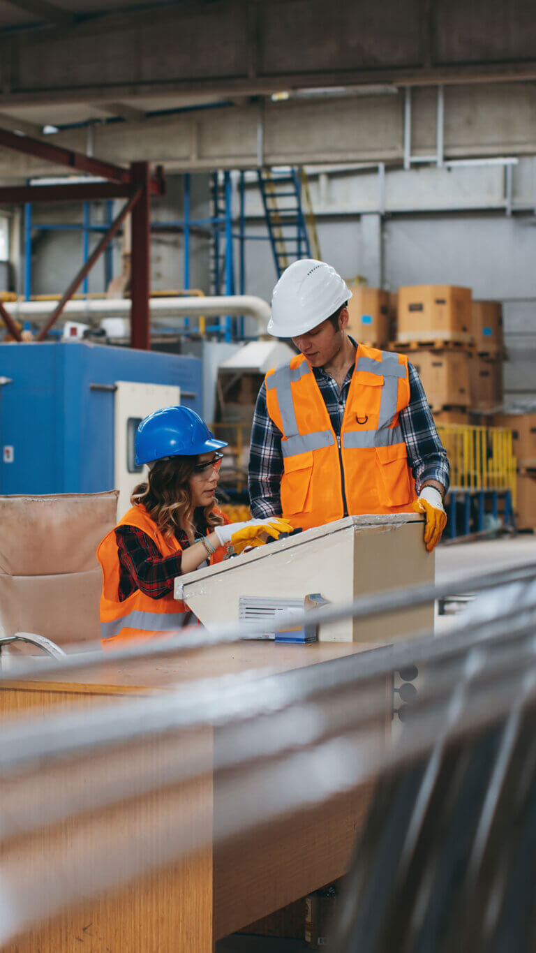 Factory employees working in a manufacturing plant that received manufacturing business loans