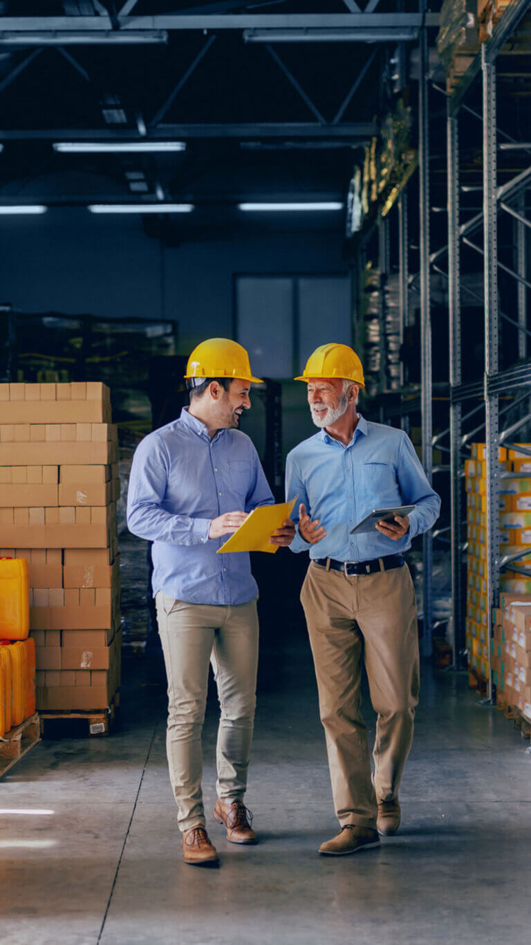 Two warehouse managers enjoying a tour through the stacks.