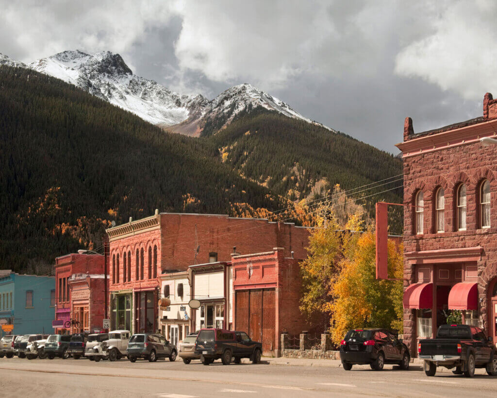 Main street looking at buildings with a mountain landscape behind.