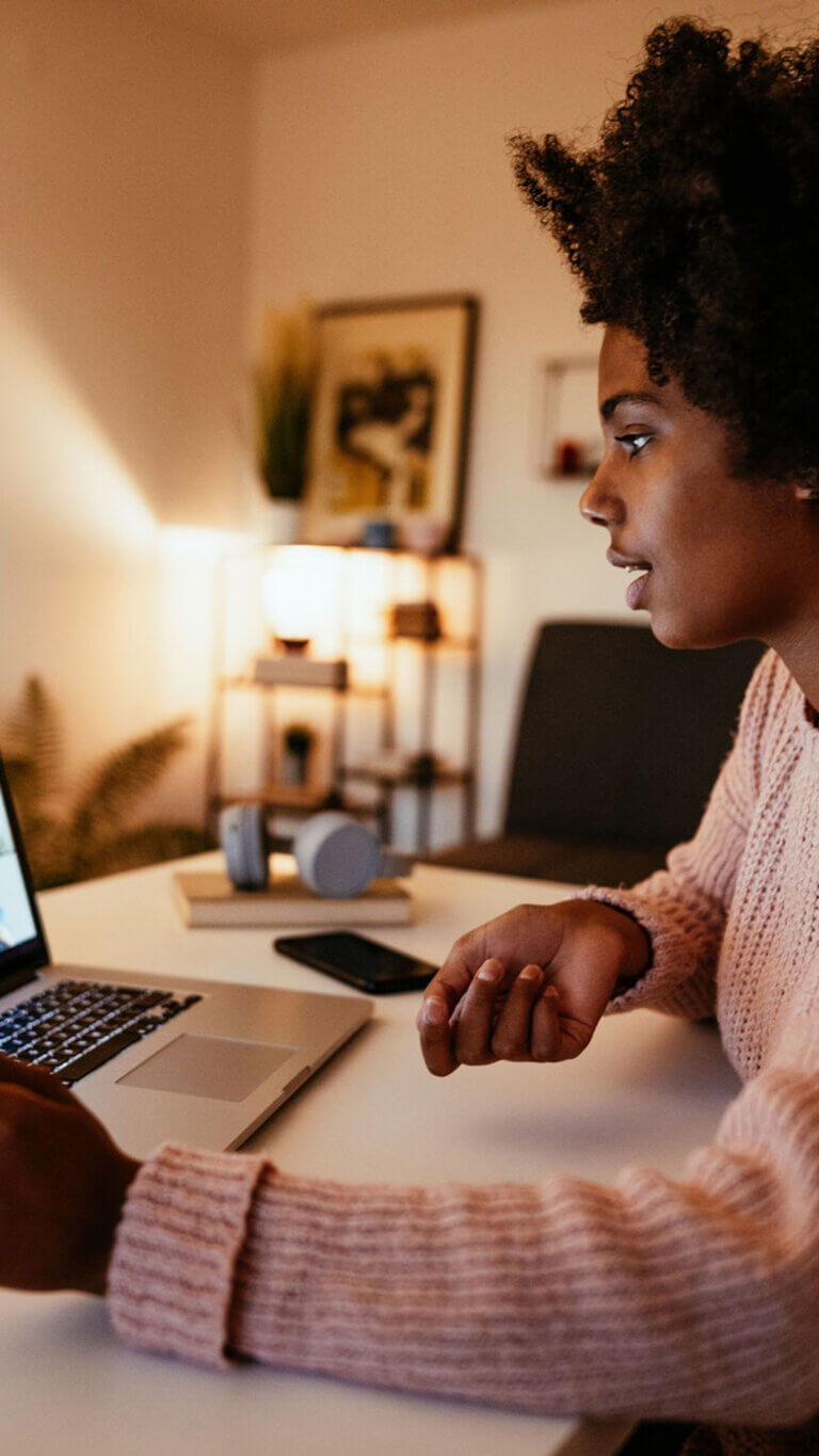 SBA loan client working from home on her laptop.