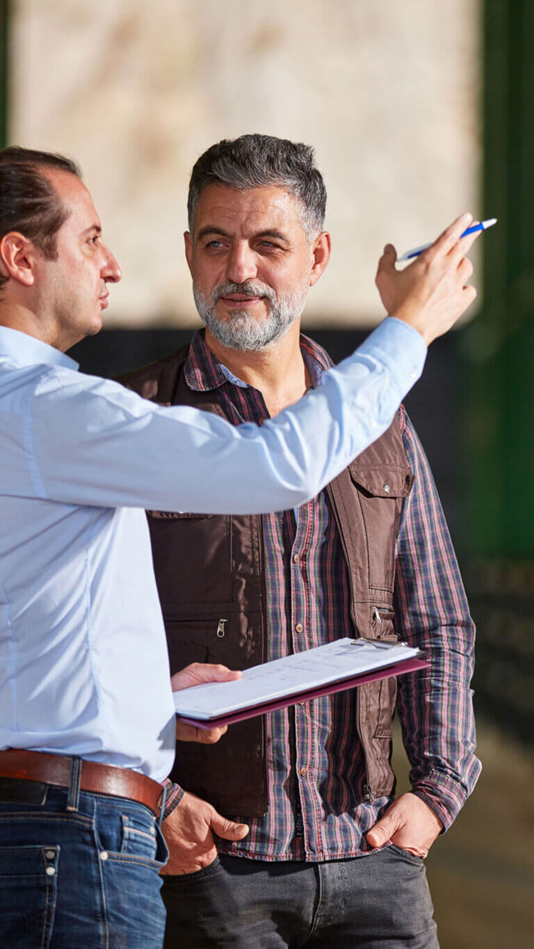 two men discussing a usda fsa first time farmer loan