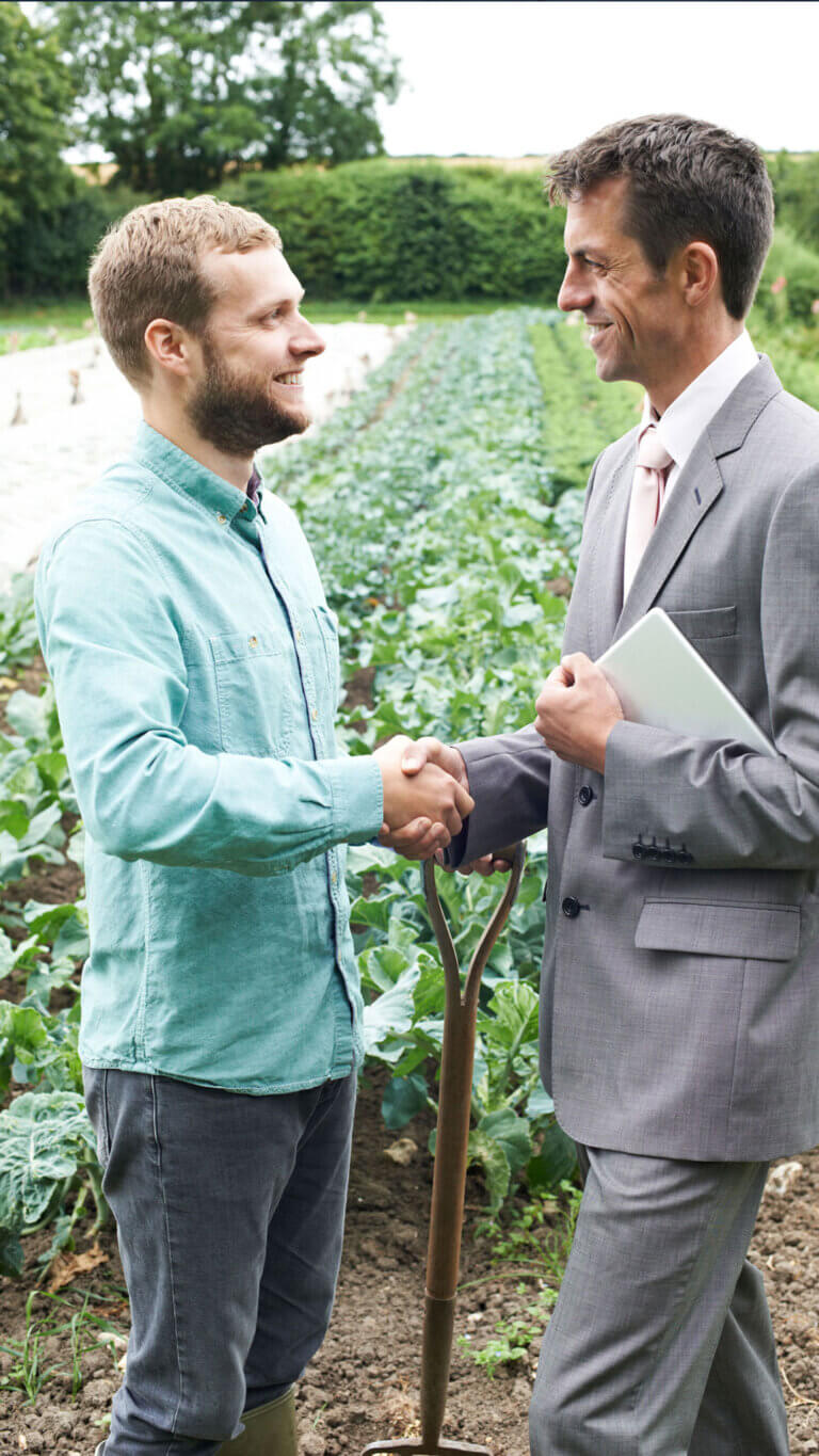 Farmer and USDA loan officer making deal on farmer's crop land.