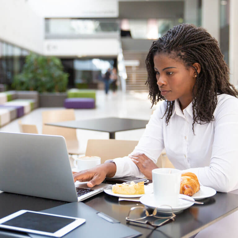 Business woman reading on laptop