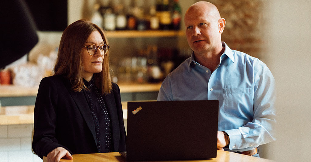 GCL executives working together at a laptop