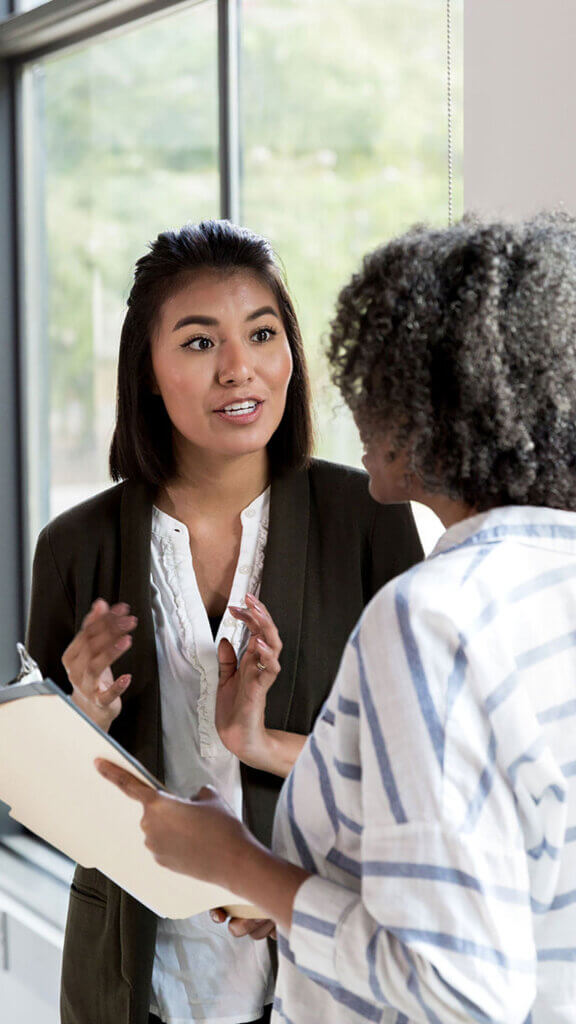 Two women employees talking together