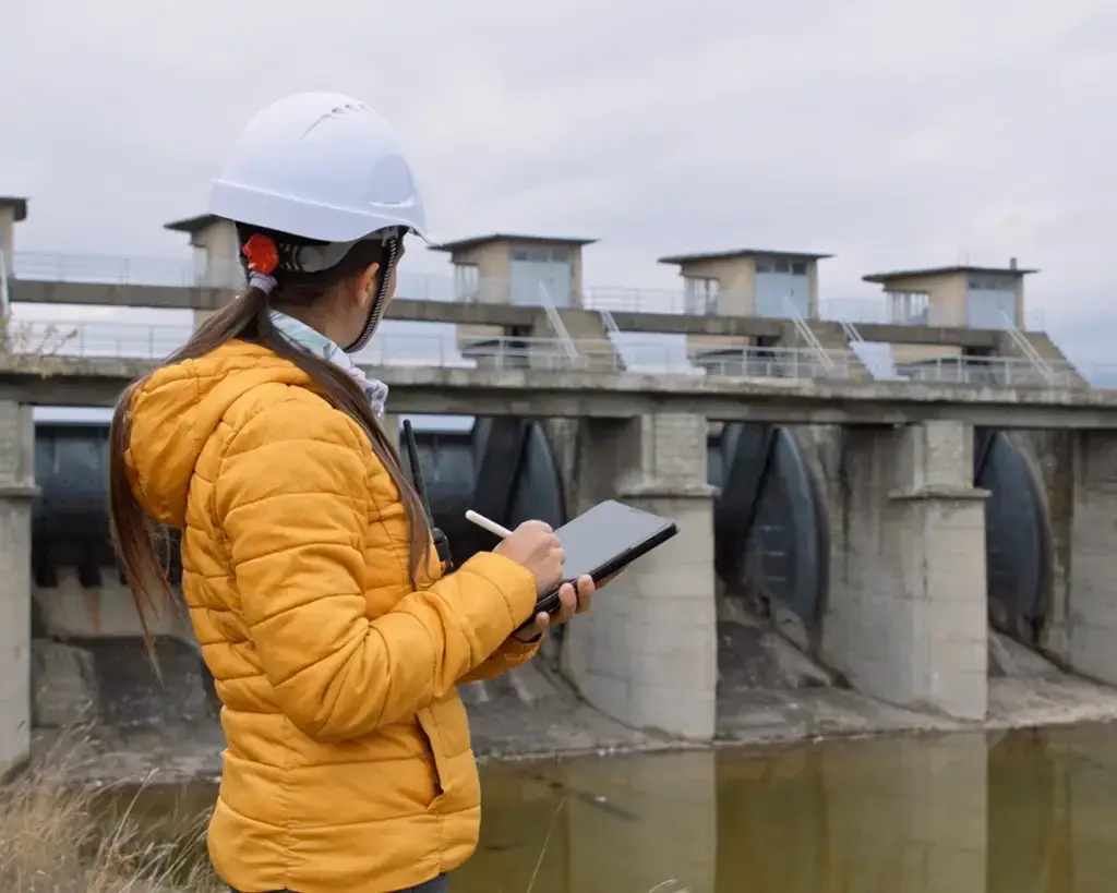 Woman looking at a water dam built with funding from a USDA Community Facility loan