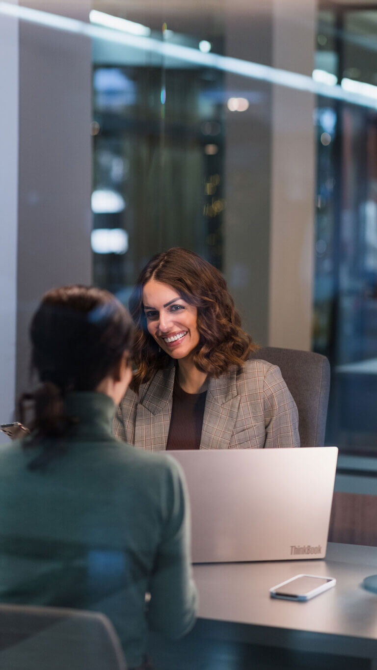 business professional woman with client discussing commercial loan servicing options