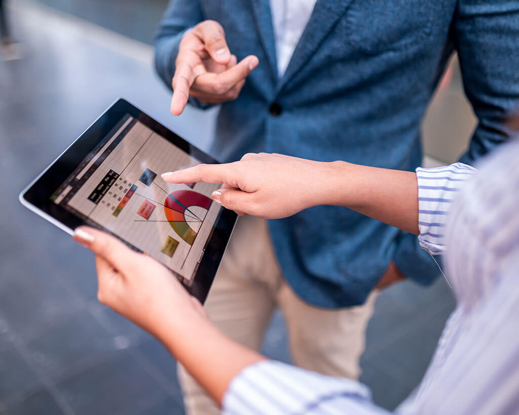 Two people looking at charts for a business loan origination application