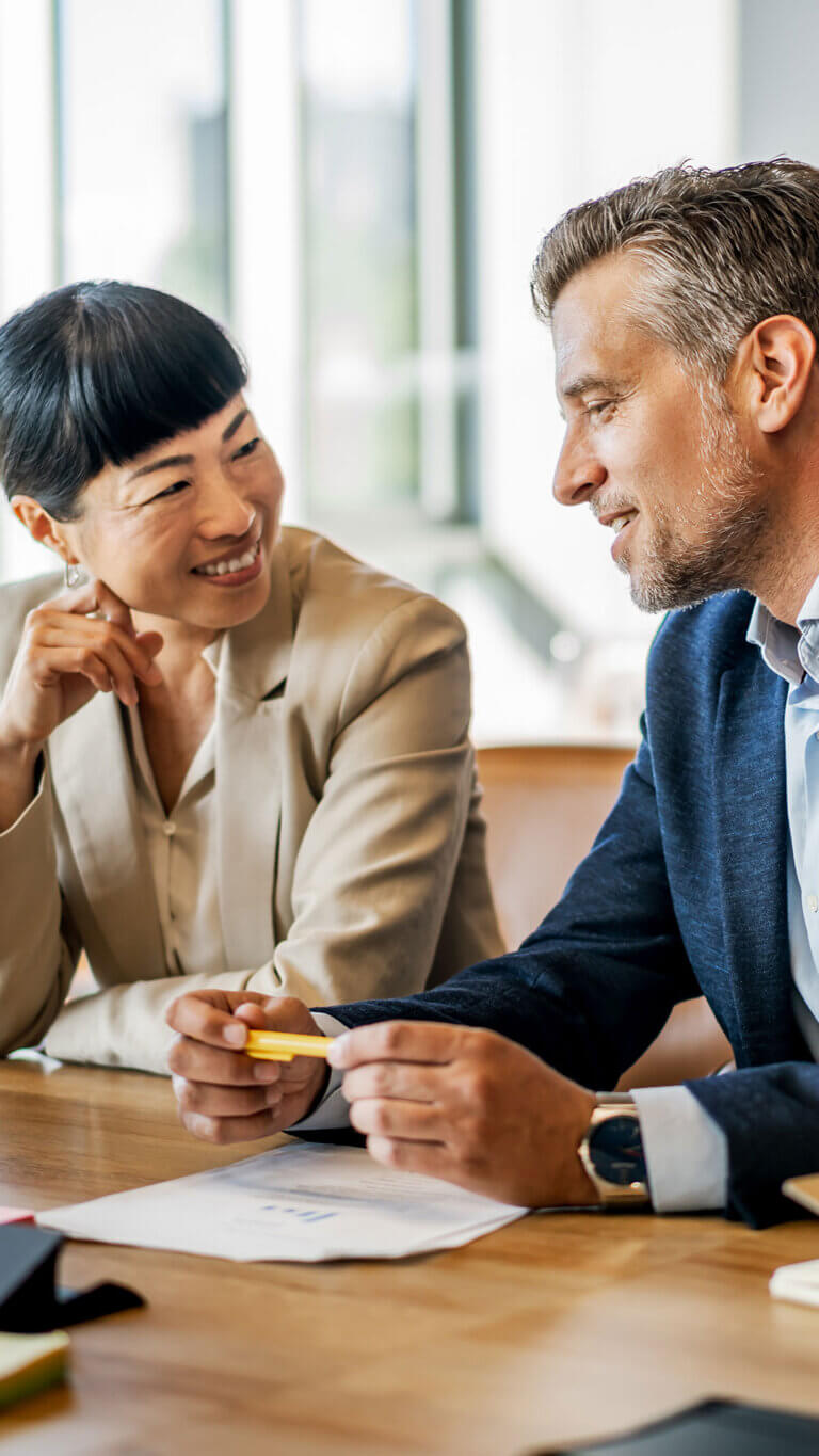 Two bank professionals discussing commercial loan participation options