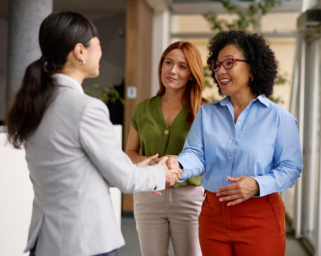 Banking business professionals shaking hands for business loan secondary market participation opportunities