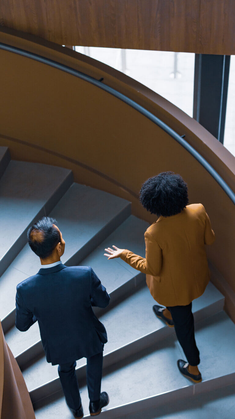 Two banking professionals talking about commercial credit administration services